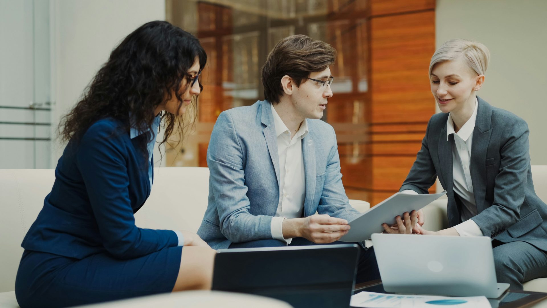AI Productivity for Financial Services Small financial services team collaborating on documents and business tasks in an office